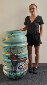 Bailey Perkins with her barrel, titled "Whisper of the Woods"