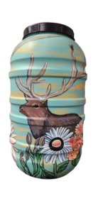 A rain barrel painted with an elk and wildflowers