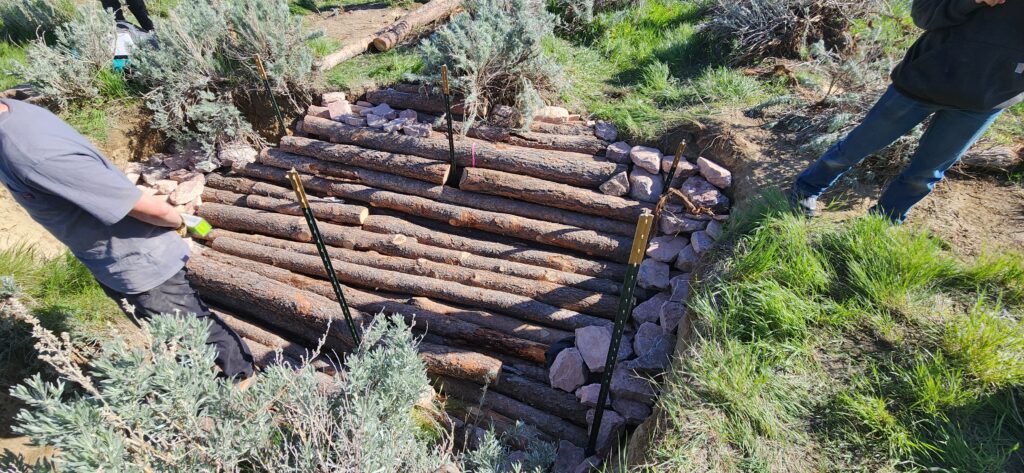 Log and fabric structure - perpendicular to flow of water